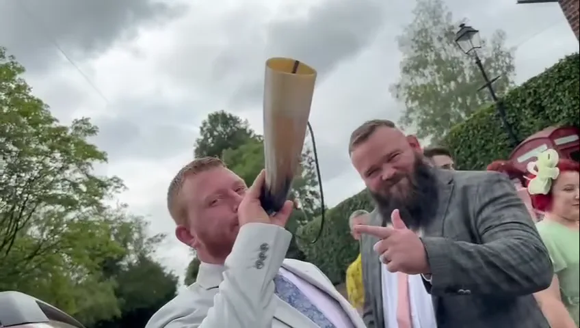 Guests toasting with a drinking horn outside the pub