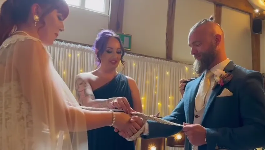 Hands bound together in a handfasting ceremony
