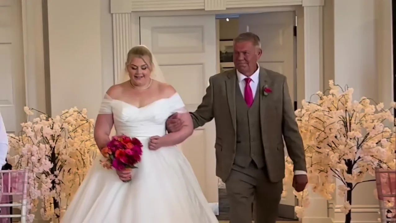 Bride being walked down the aisle